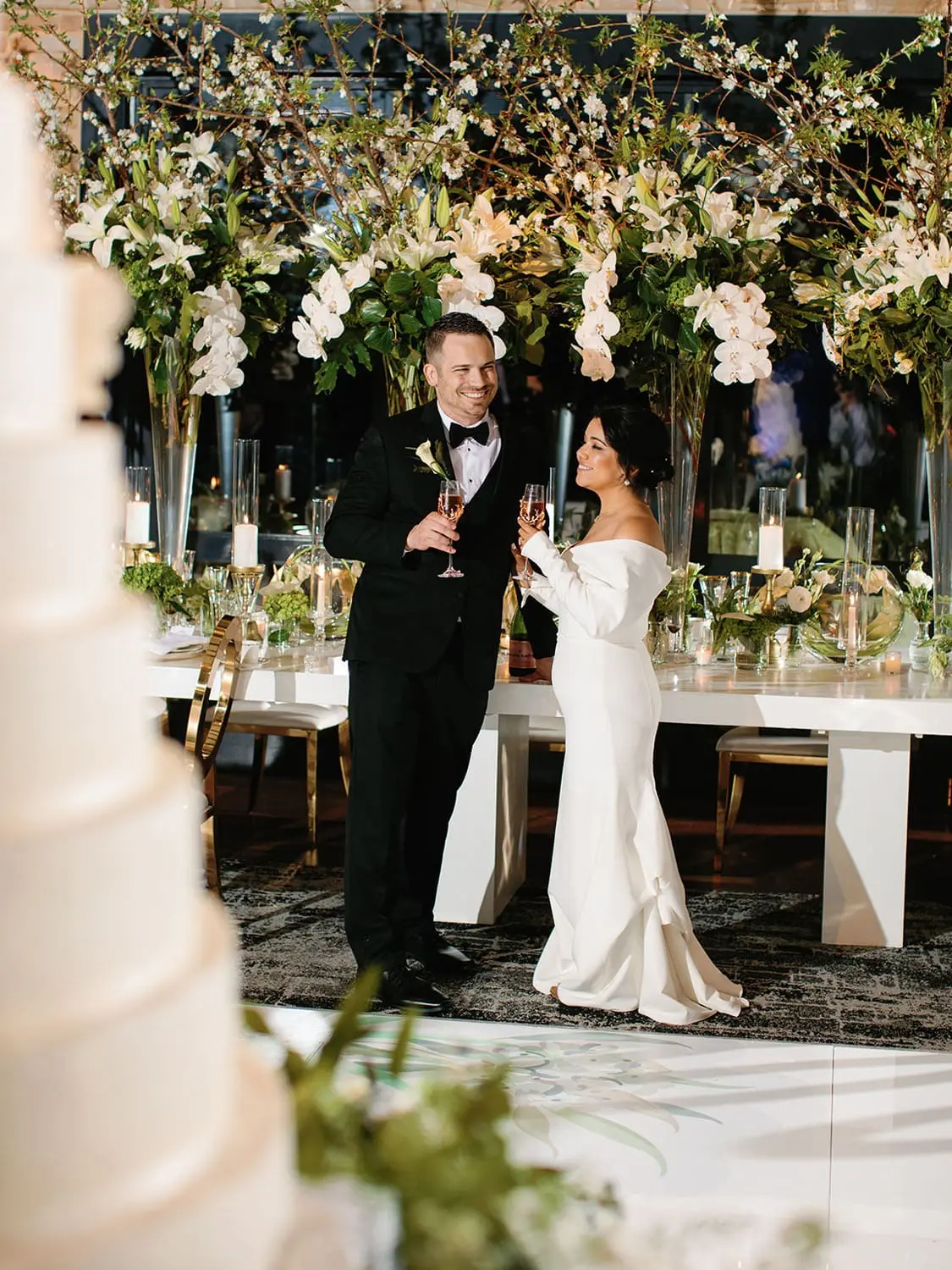 bride and groom under floral arrangement