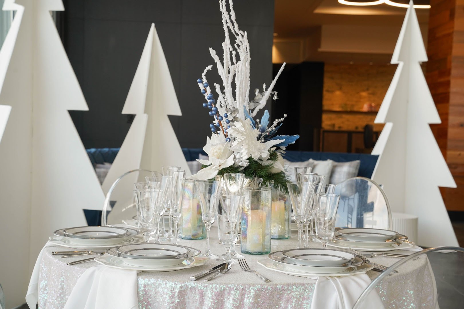 A beautifully decorated winter wedding reception with snowflakes, twinkling lights, and elegant table settings.